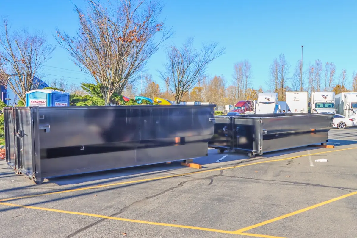 Professional dumpster rental service with roll-off container on residential driveway in Lawrenceburg